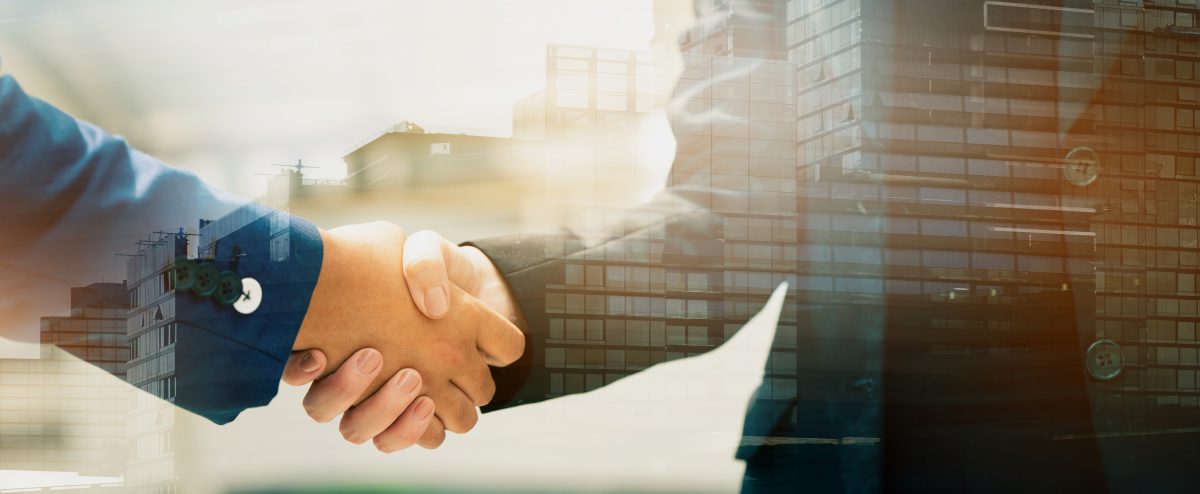 Close up of a business people with a handshake Agreements to do business together show trust and confidence in the investment in real estate. copy space of banner