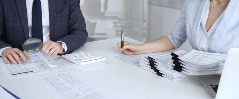 Two auditors performing a financial diligence review